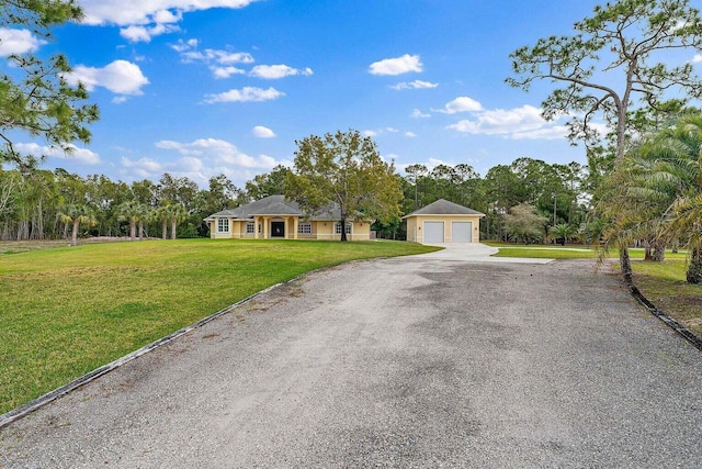 ranch-style house featuring a garage and a front lawn