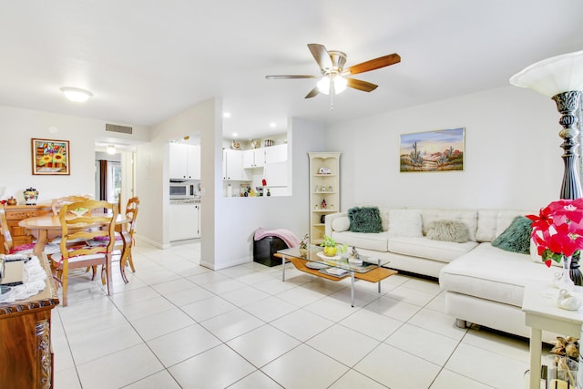 living room with ceiling fan and light tile patterned floors