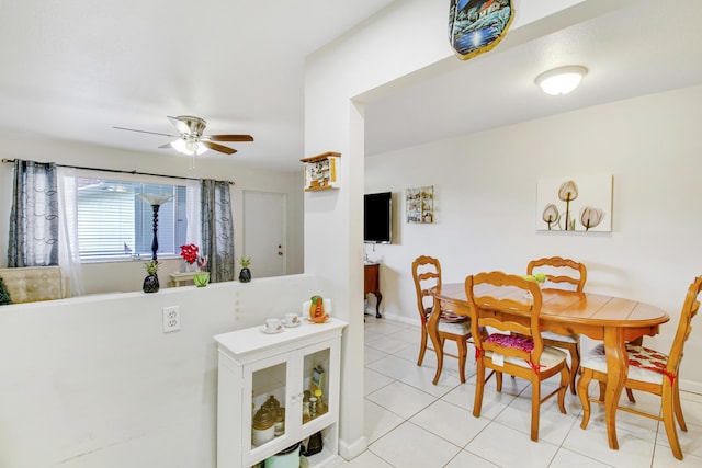 tiled dining space featuring ceiling fan