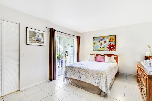 tiled bedroom with access to exterior and a closet