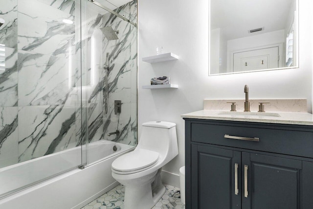 full bathroom featuring shower / bath combination with glass door, vanity, and toilet