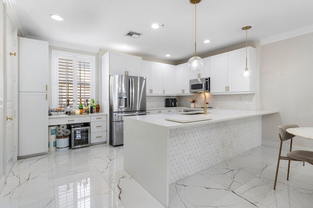 kitchen featuring backsplash, stainless steel appliances, sink, pendant lighting, and white cabinets