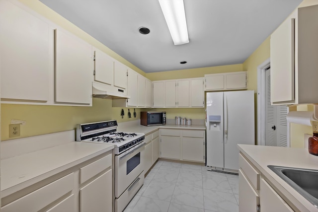 kitchen with white appliances and white cabinets