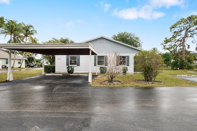 ranch-style house with a front lawn and a carport