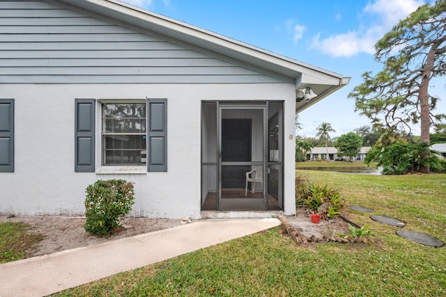 entrance to property with a yard