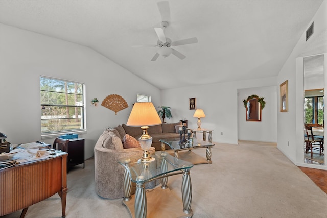 living room featuring vaulted ceiling, ceiling fan, and light colored carpet