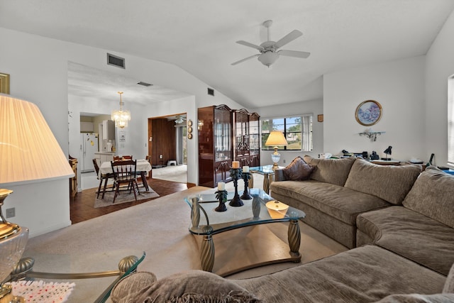 living room featuring vaulted ceiling, ceiling fan with notable chandelier, and tile patterned floors