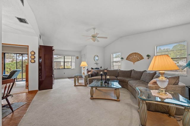 tiled living room featuring ceiling fan and lofted ceiling