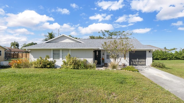 single story home with a front yard and a garage