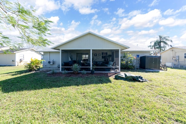 rear view of property with a lawn and a sunroom