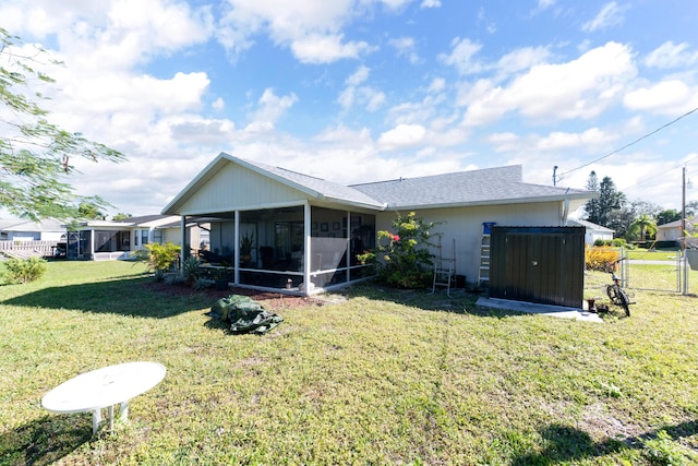 back of house featuring a sunroom and a yard