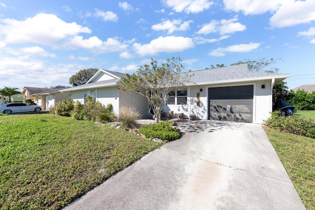 single story home featuring a garage and a front lawn