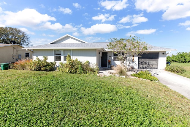 ranch-style home with a garage and a front lawn