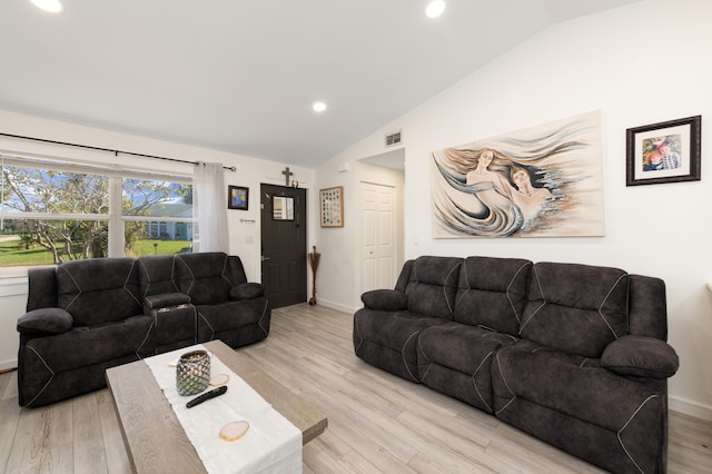 living room with light hardwood / wood-style floors and vaulted ceiling