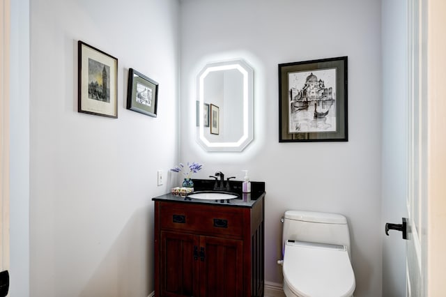 bathroom featuring vanity and toilet