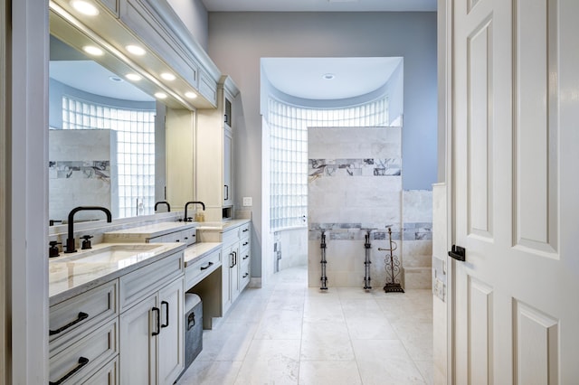 bathroom with vanity, tile patterned floors, and tile walls