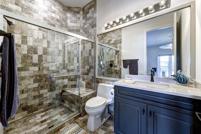 bathroom featuring vanity, toilet, and an enclosed shower