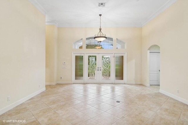 interior space with light tile patterned floors, ornamental molding, a high ceiling, and french doors