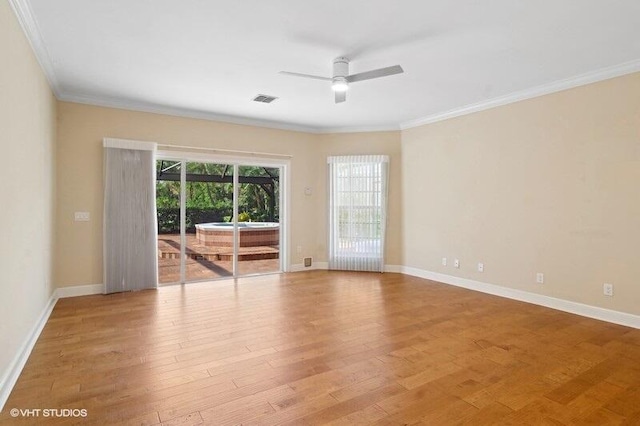 empty room featuring ceiling fan, light hardwood / wood-style floors, and ornamental molding