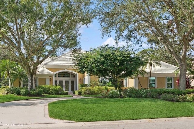 view of front of property with a front lawn and french doors