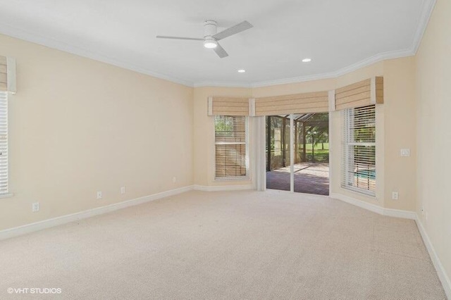 carpeted empty room with ceiling fan and ornamental molding