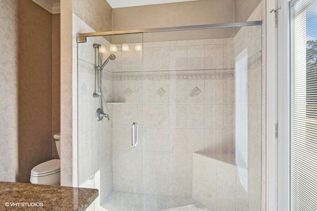 bathroom with toilet and walk in shower