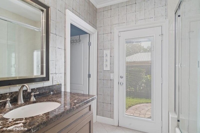 bathroom with tile patterned floors, vanity, ornamental molding, and a wealth of natural light