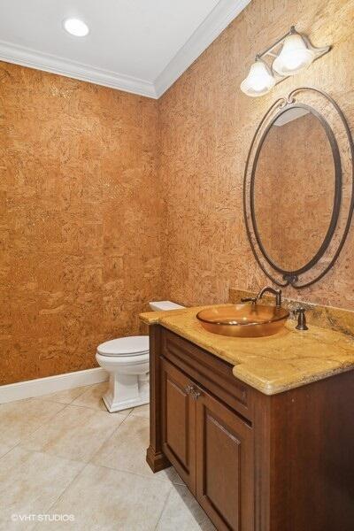 bathroom featuring tile patterned floors, vanity, toilet, and ornamental molding