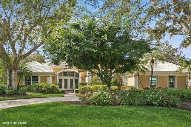 view of front of home with french doors and a front yard