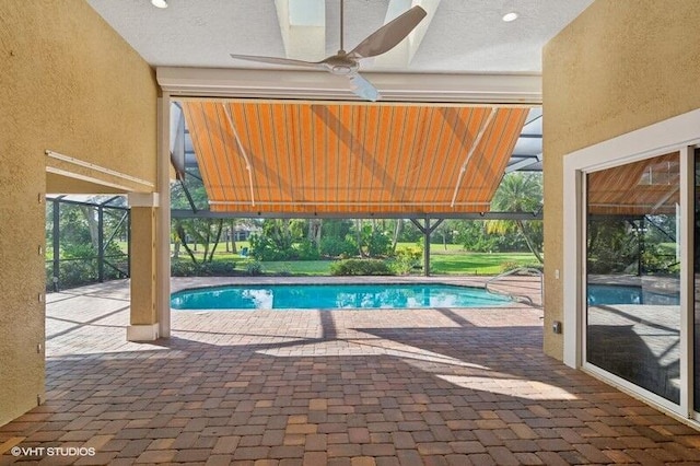 view of swimming pool with a patio area and ceiling fan