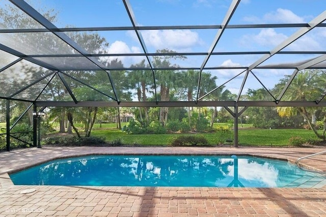 view of swimming pool featuring a patio and glass enclosure