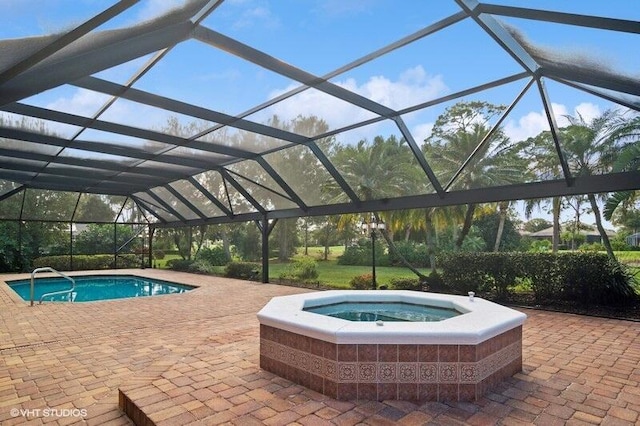 view of pool with a patio and glass enclosure