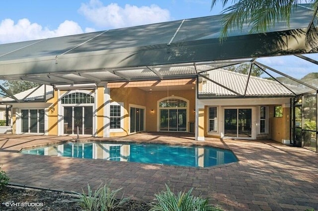 view of swimming pool with a patio and a lanai