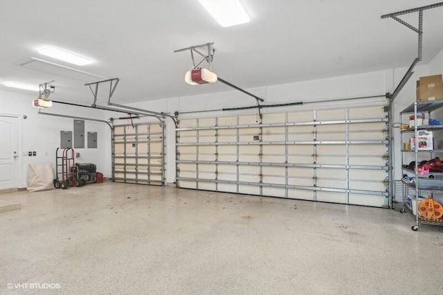 garage with electric panel and a garage door opener