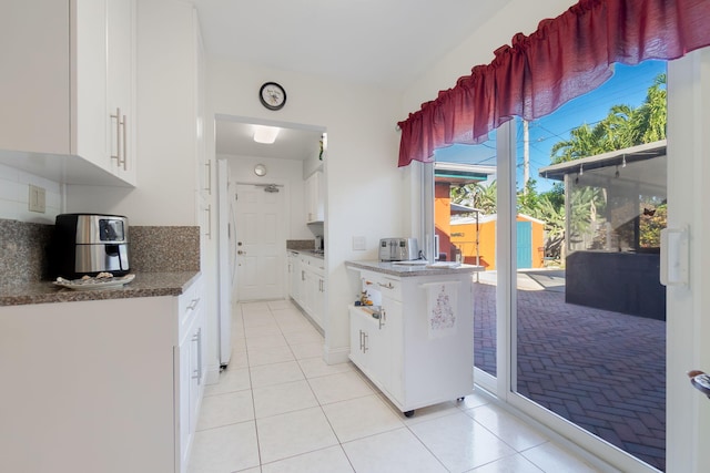 kitchen featuring white cabinets and light tile patterned floors