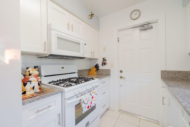 kitchen with white cabinetry, light stone counters, white appliances, decorative backsplash, and light tile patterned floors