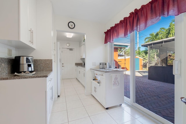 1503 Shirley Ct, Lake Worth, FL 33461 - kitchen featuring light tile patterned floors, white cabinetry, and dark countertops