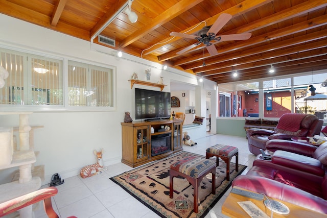 living room with beamed ceiling, light tile patterned floors, ceiling fan, and wooden ceiling