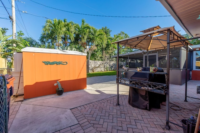 view of patio with a sunroom, a gazebo, and an outdoor structure