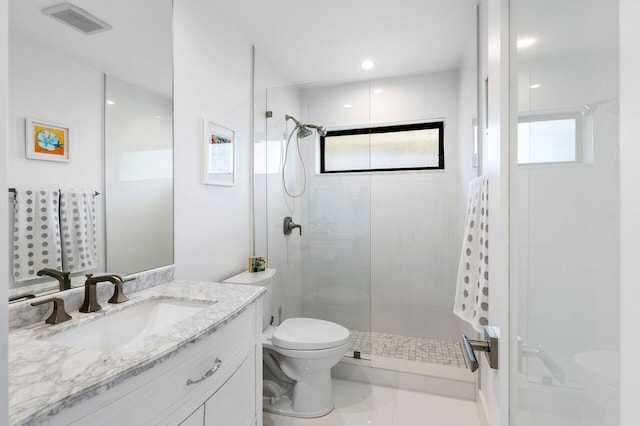 bathroom featuring tile patterned flooring, vanity, toilet, and walk in shower