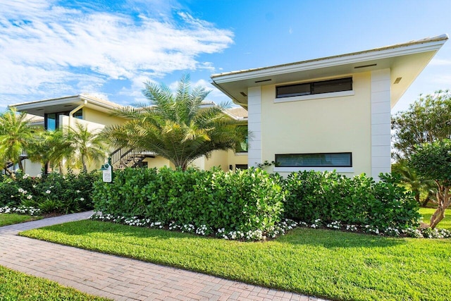 view of side of home featuring a yard