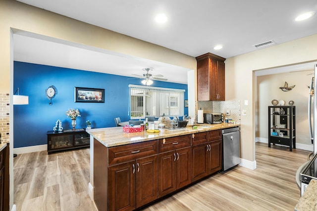 kitchen featuring dishwasher, backsplash, light stone countertops, light wood-type flooring, and kitchen peninsula