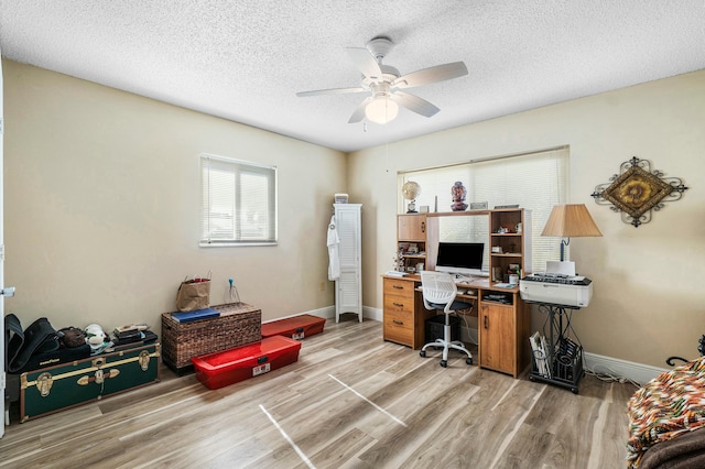 office space featuring a textured ceiling, light hardwood / wood-style flooring, and ceiling fan