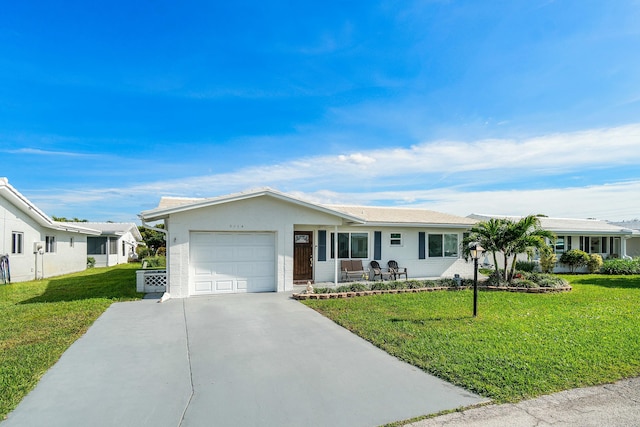 single story home featuring a garage and a front lawn