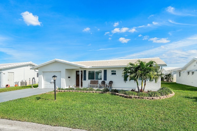 ranch-style home with a porch, central AC unit, a garage, and a front lawn