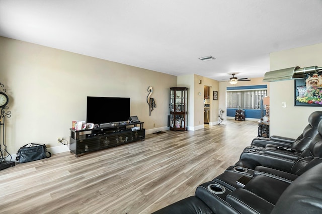 living room with ceiling fan and hardwood / wood-style floors