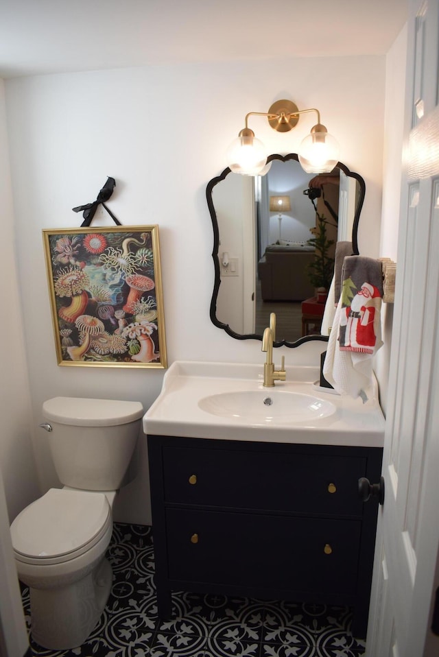 bathroom with vanity, tile patterned flooring, and toilet