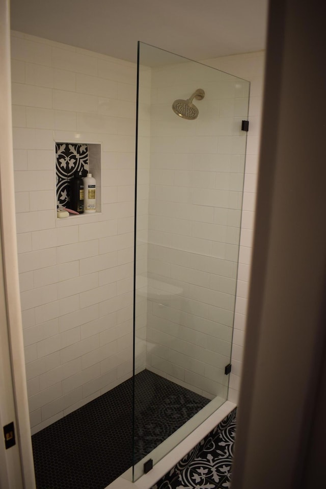 bathroom with a tile shower