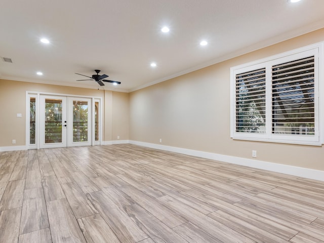 spare room with crown molding, light hardwood / wood-style floors, french doors, and ceiling fan