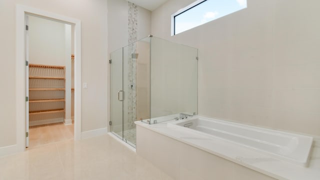 bathroom with tile patterned flooring and independent shower and bath